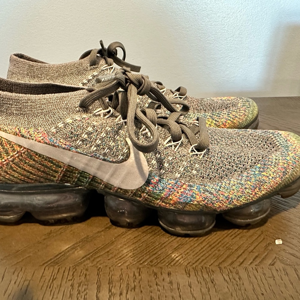 Nike gray running shoes. Lots of colors in them.